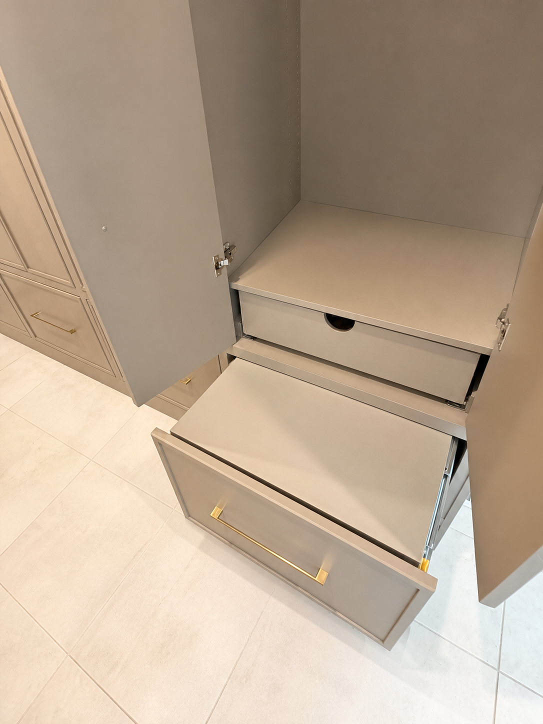 Heavy-duty pull-out shoe storage drawer that doubles as a mudroom step