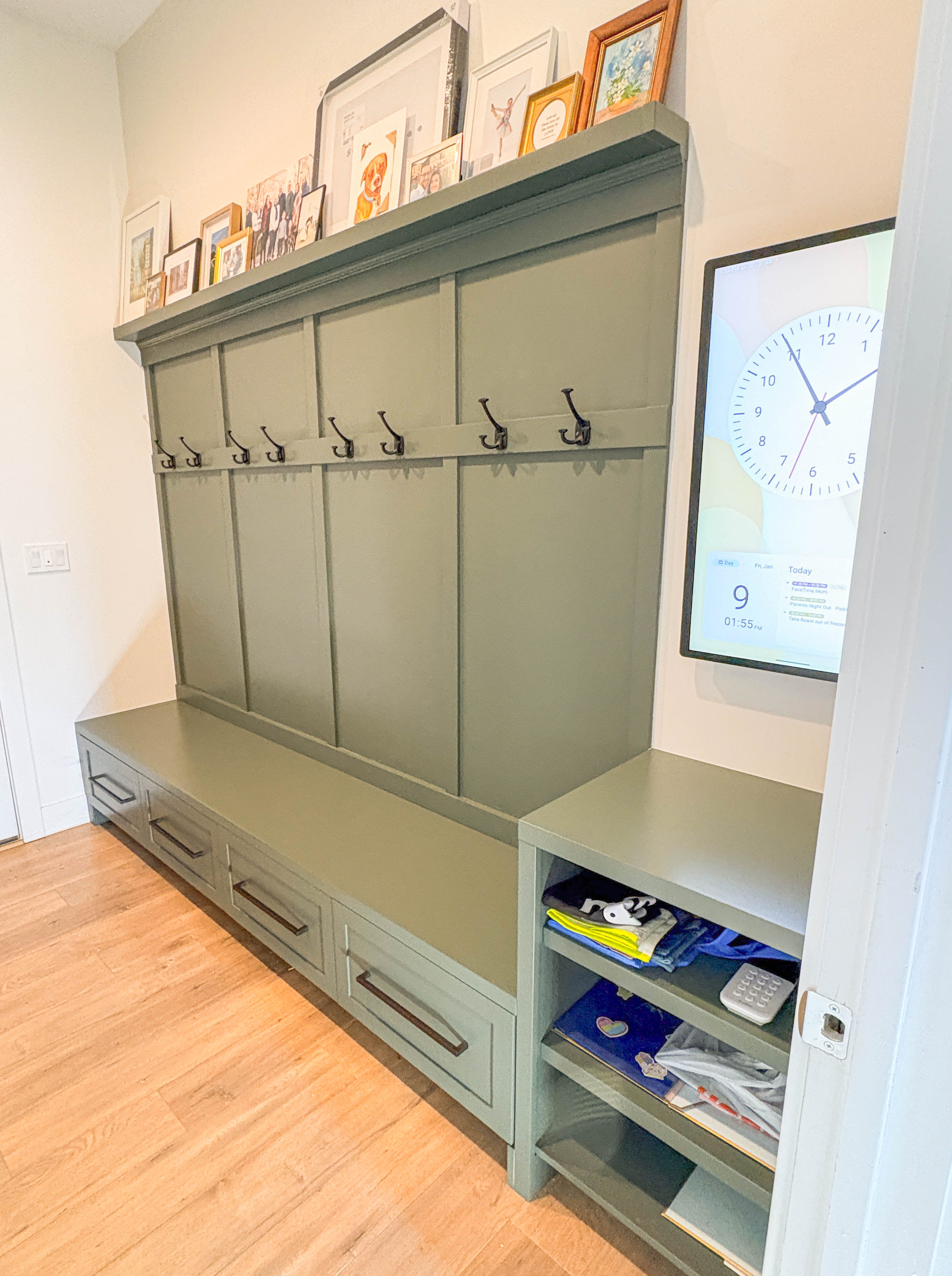 Custom mudroom built-in with bench, drawers, and coat hooks